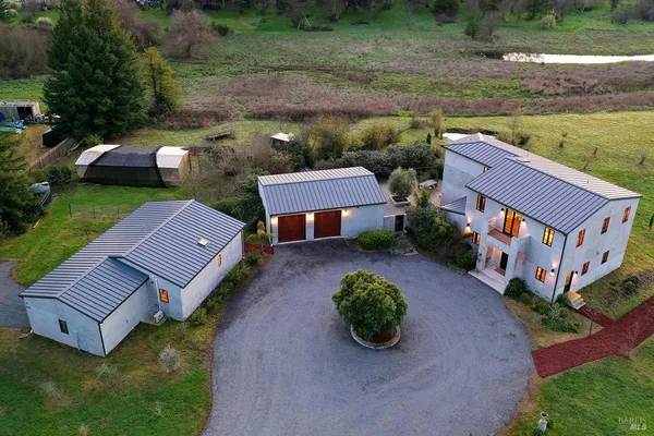 an aerial view of a house with garden space and a street view