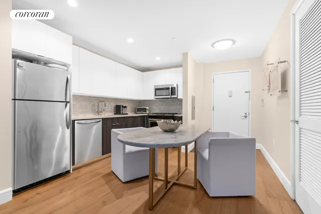 a kitchen with stainless steel appliances granite countertop a refrigerator a sink a stove a microwave a center island and a refrigerator