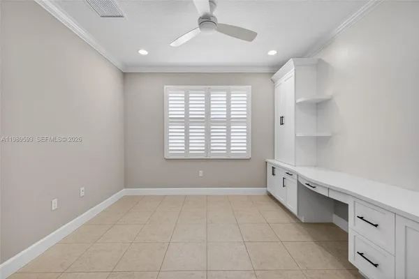 an empty room with closet and windows