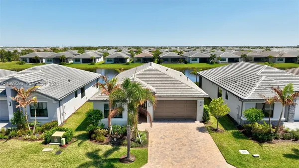 a living room with furniture ceiling fan and a large window