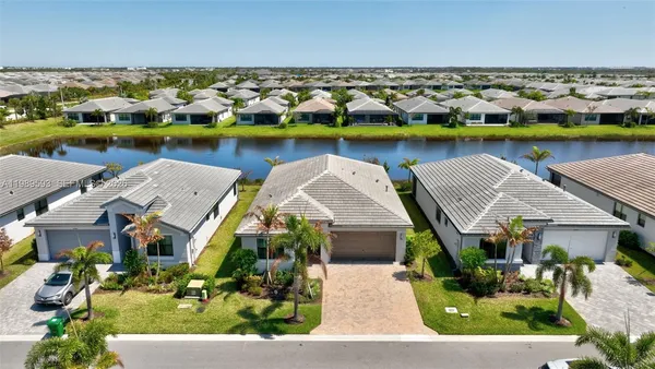 a view of house with swimming pool and outdoor seating