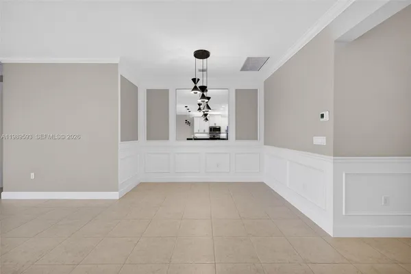 a large kitchen with kitchen island a sink a counter and stainless steel appliances