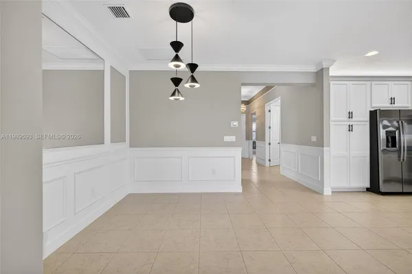 a kitchen with granite countertop a refrigerator oven a sink and cabinets