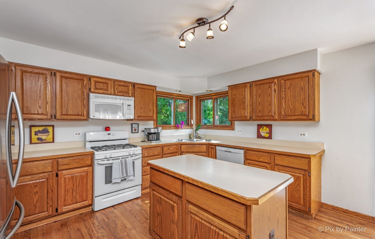 120 Briargate Road Cary, IL 60013 - Photo 11 of 35 a kitchen with a sink stove top oven and refrigerator