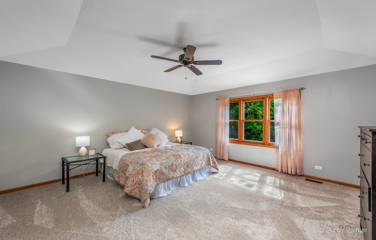 120 Briargate Road Cary, IL 60013 - Photo 16 of 35 a bedroom with a bed and a ceiling fan