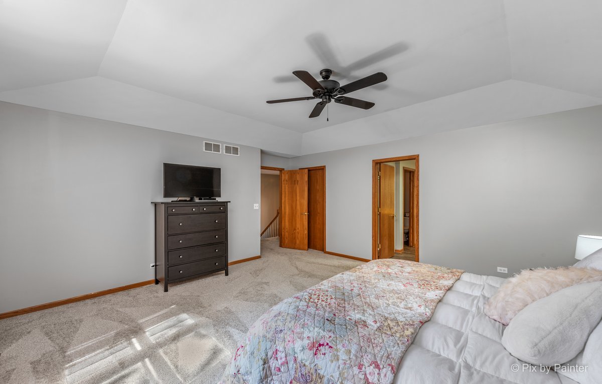 120 Briargate Road Cary, IL 60013 - Photo 17 of 35 a bedroom with a bed and a tv on a dresser
