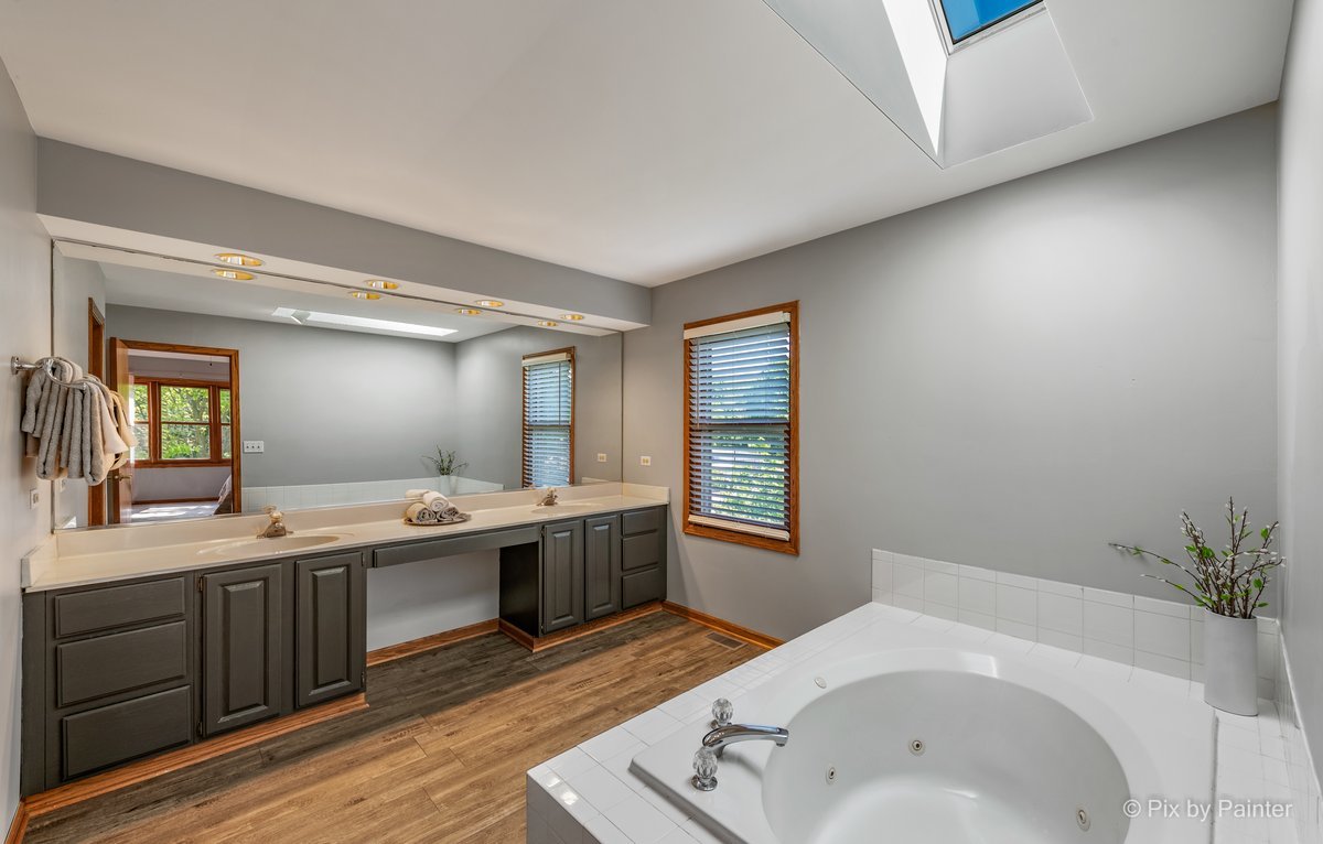 120 Briargate Road Cary, IL 60013 - Photo 18 of 35 a spacious bathroom with a tub sink and mirror