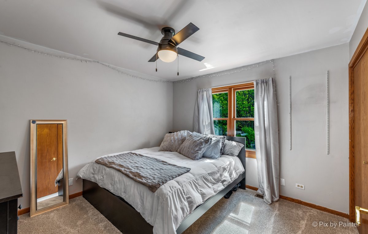 120 Briargate Road Cary, IL 60013 - Photo 20 of 35 a bedroom with a large bed and a window