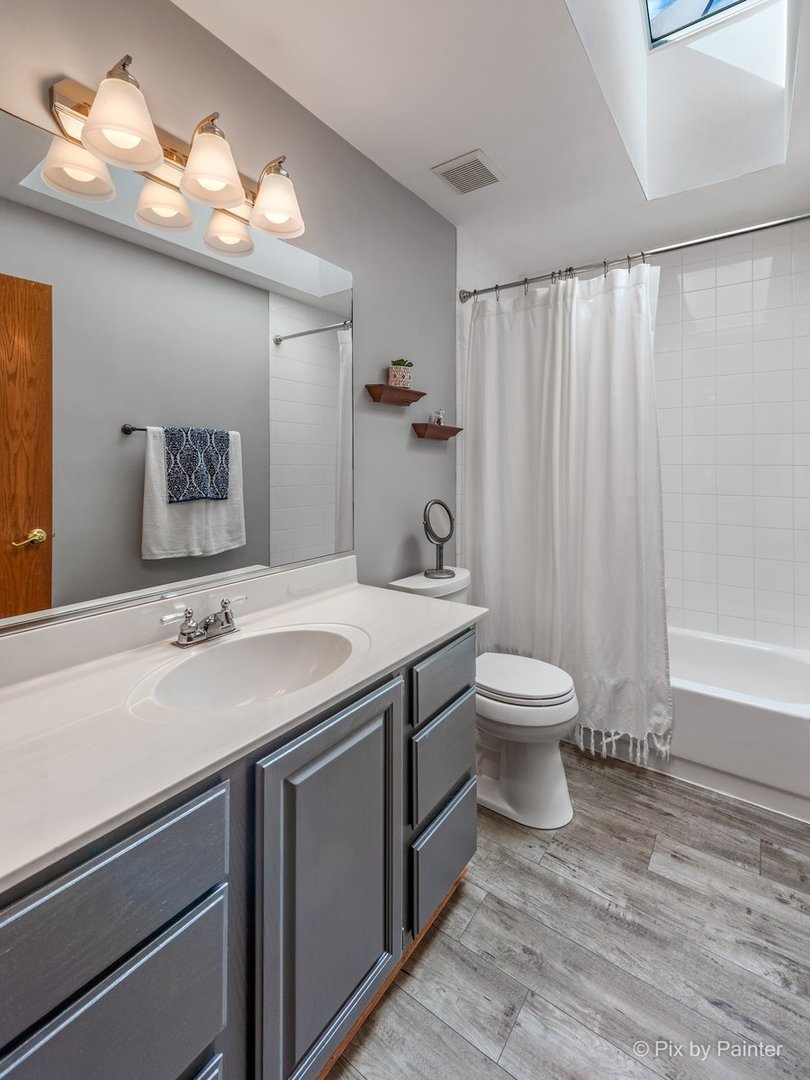 120 Briargate Road Cary, IL 60013 - Photo 25 of 35 a bathroom with a granite countertop sink a toilet and a mirror