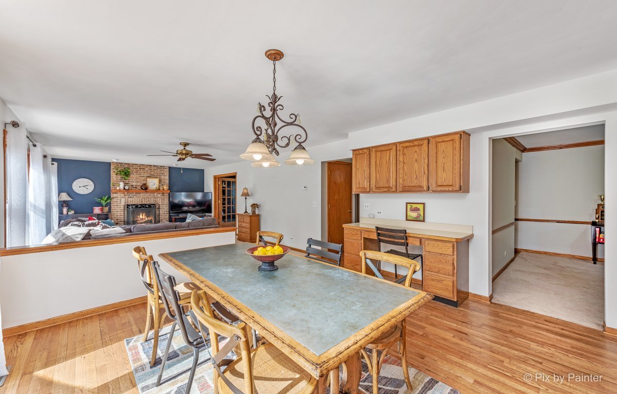 120 Briargate Road Cary, IL 60013 - Photo 6 of 35 a view of a dining room and livingroom with furniture wooden floor a chandelier