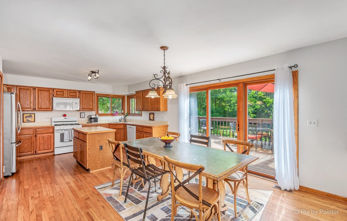 120 Briargate Road Cary, IL 60013 - Photo 7 of 35 a very nice looking dining room with a large window kitchen island a counter space and stainless steel appliances