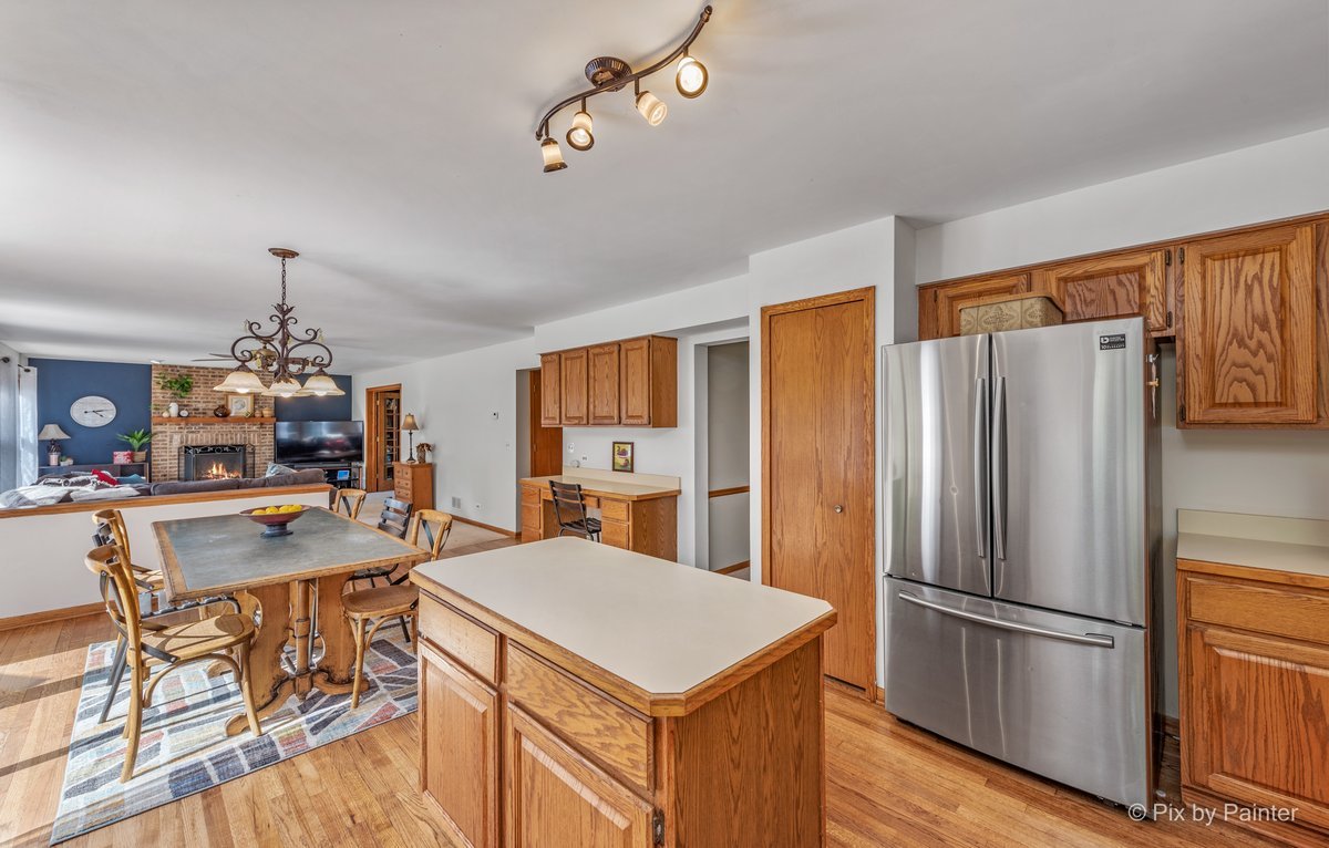 120 Briargate Road Cary, IL 60013 - Photo 9 of 35 a kitchen with refrigerator cabinets and wooden floor