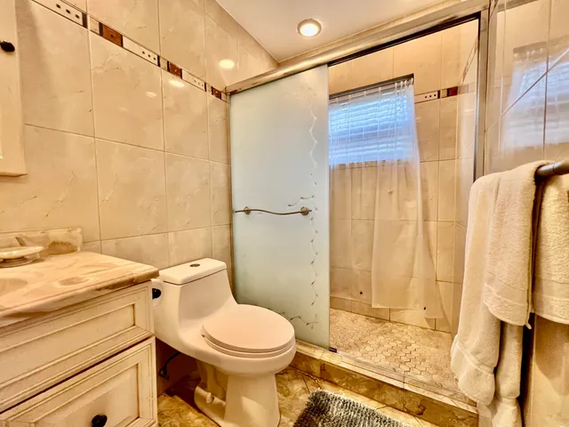 a view of a tennis ground with large trees