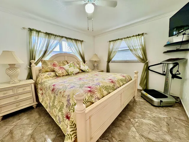 a front view of a house with swimming pool and sitting area