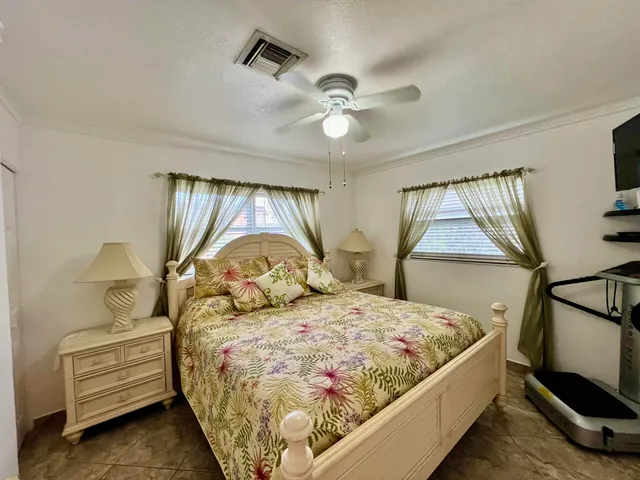 a view of a swimming pool with lawn chairs under an umbrella