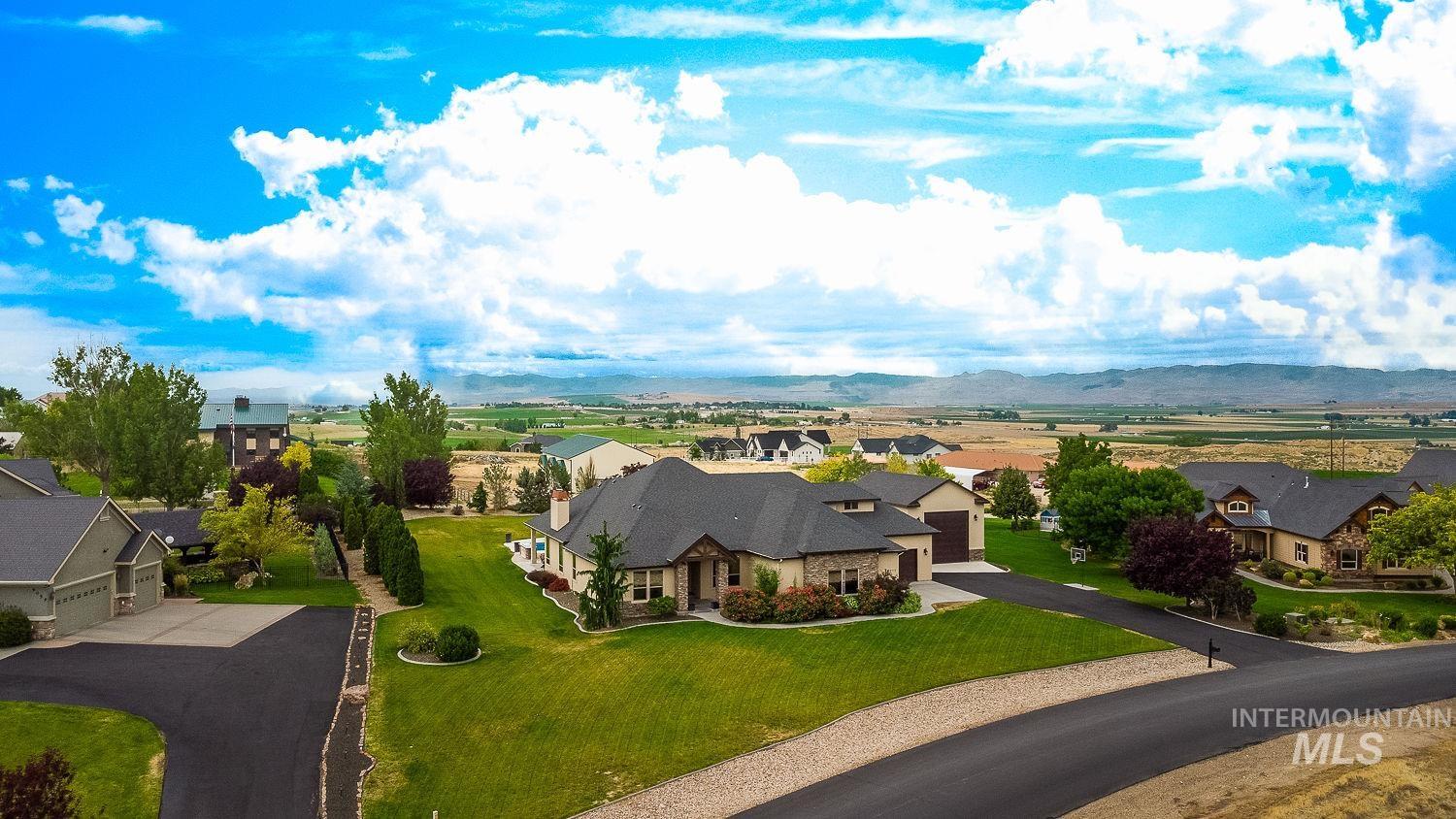 8077 Star Pass Ridge Road Nampa, ID 83686 - Photo 5 of 37 Ranch-style residence featuring a stone and stucco exterior, dark roof, and an attached two-car garage
