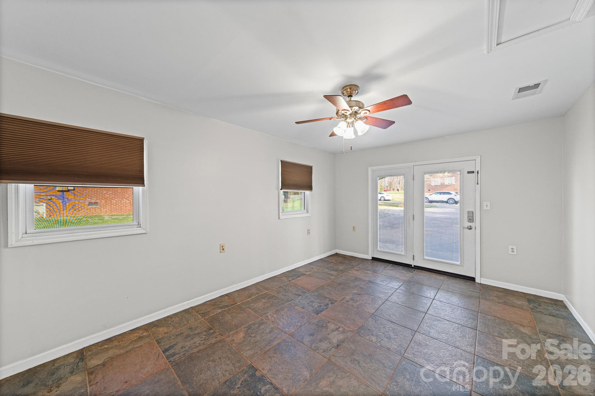 3227 Westover Road Statesville, NC 28677 - Photo 12 of 37 an empty room with windows and ceiling fan