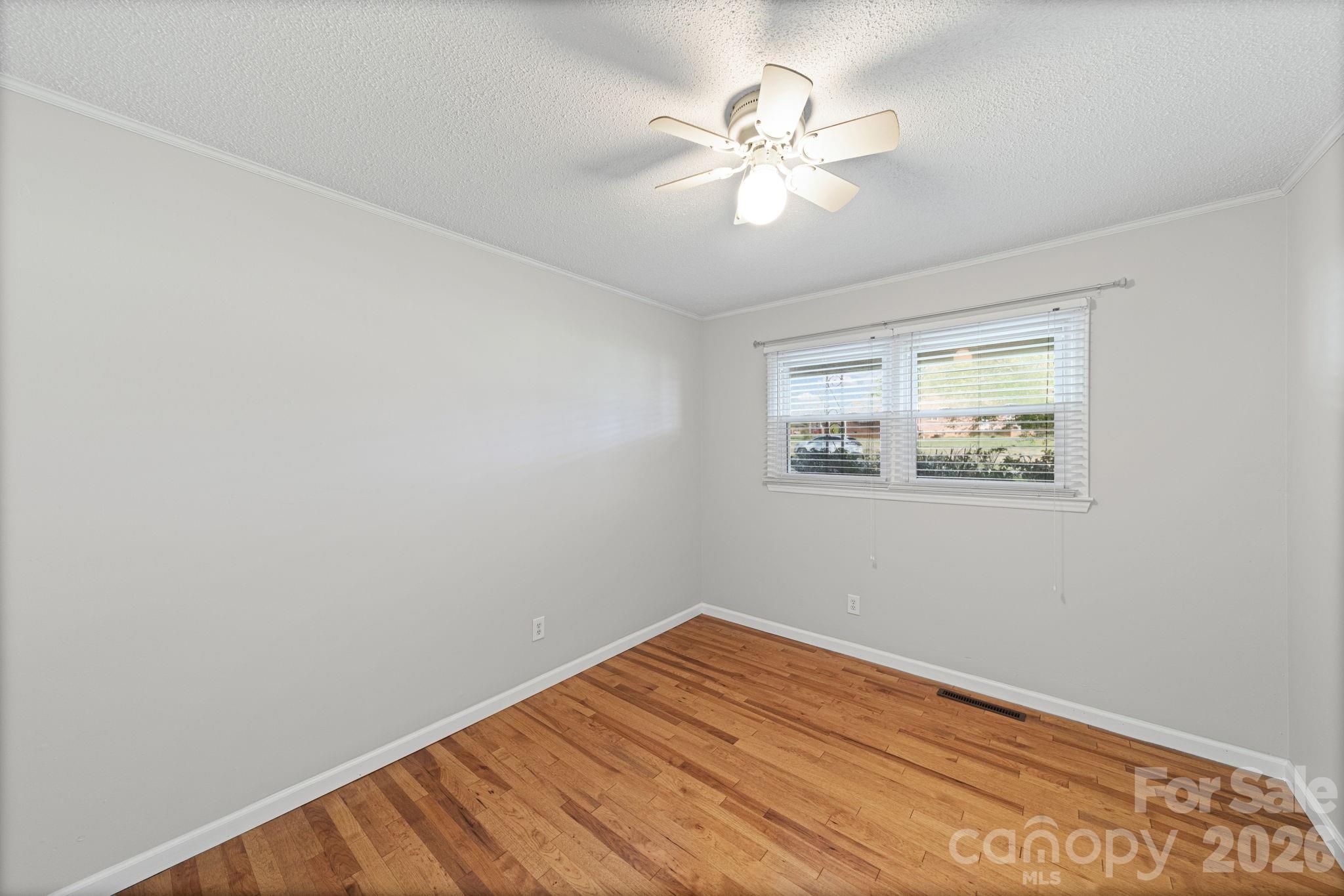 3227 Westover Road Statesville, NC 28677 - Photo 14 of 37 a view of a room with wooden floor and a ceiling fan