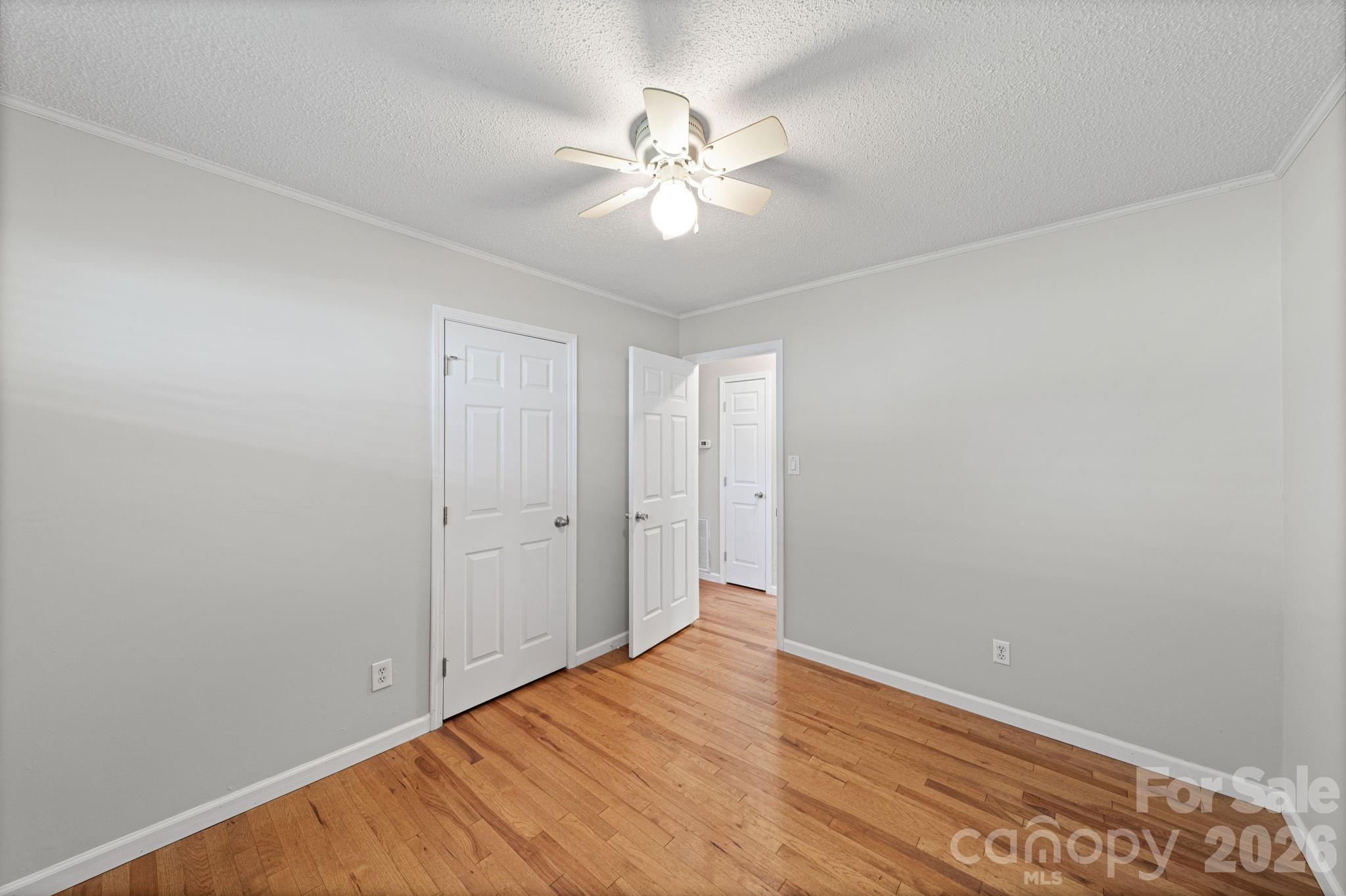 3227 Westover Road Statesville, NC 28677 - Photo 15 of 37 a view of a room with wooden floor and fan