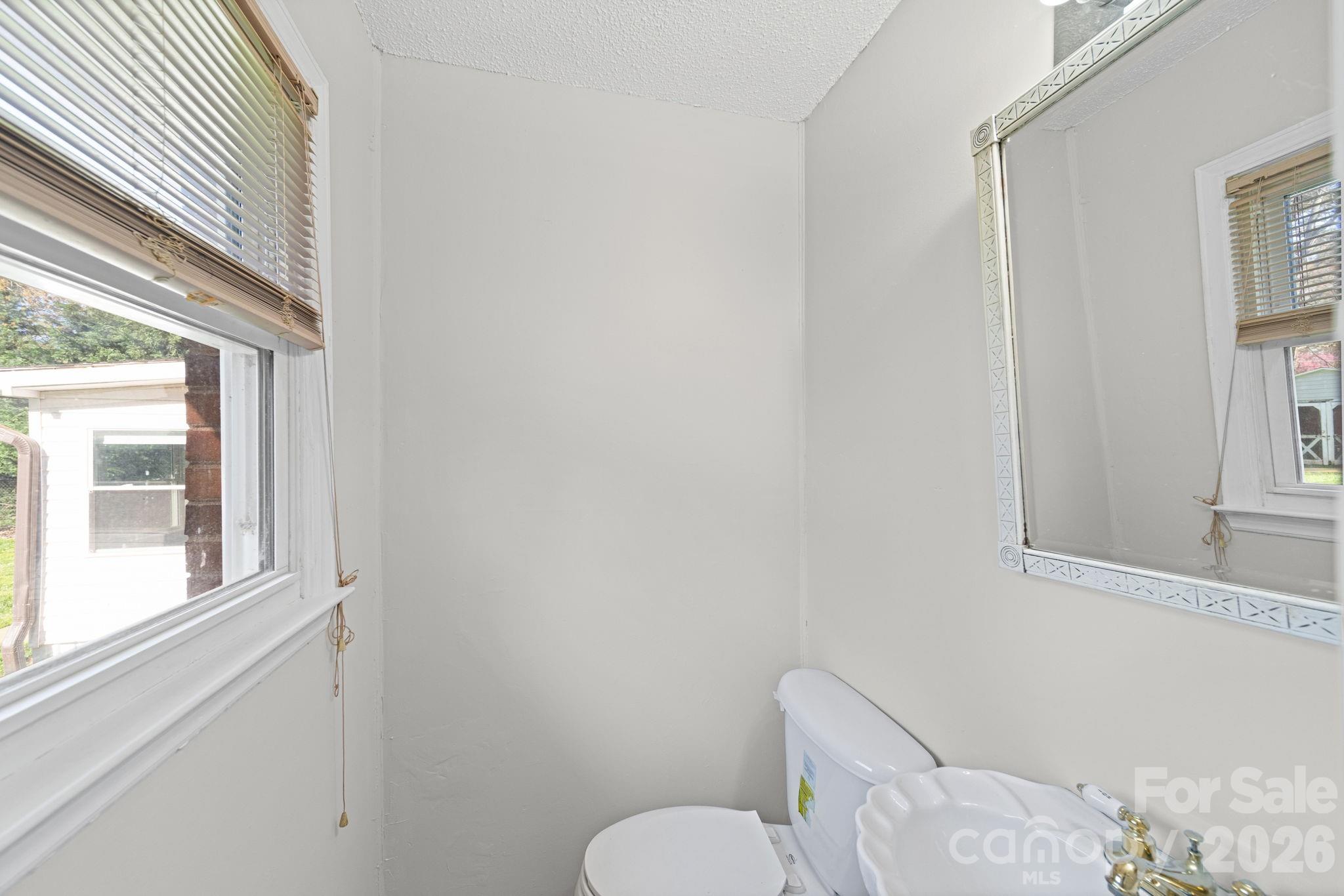 3227 Westover Road Statesville, NC 28677 - Photo 19 of 37 a white toilet sitting next to a window