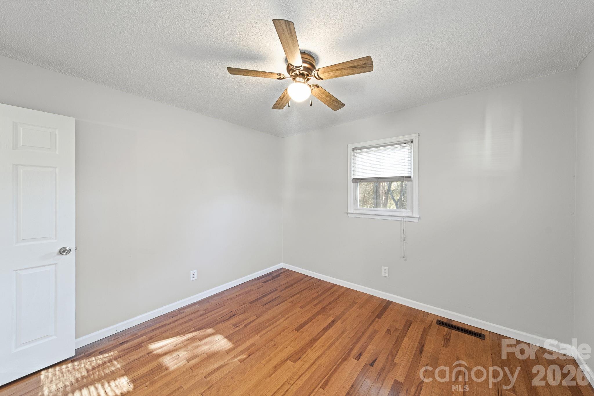 3227 Westover Road Statesville, NC 28677 - Photo 20 of 37 a view of room with window and ceiling fan