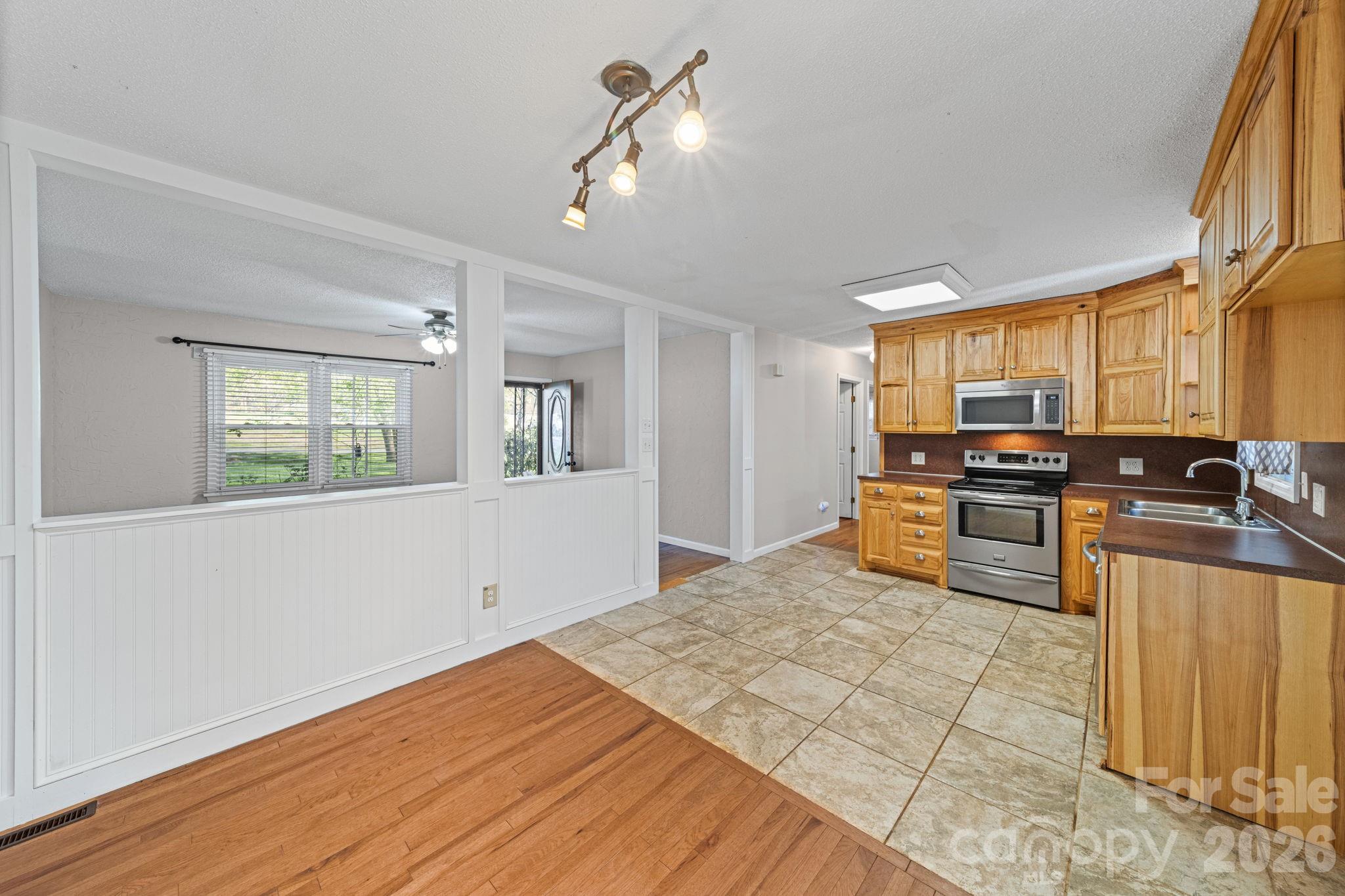 3227 Westover Road Statesville, NC 28677 - Photo 2 of 37 a kitchen with stainless steel appliances granite countertop a stove a sink dishwasher and a refrigerator with wooden floor