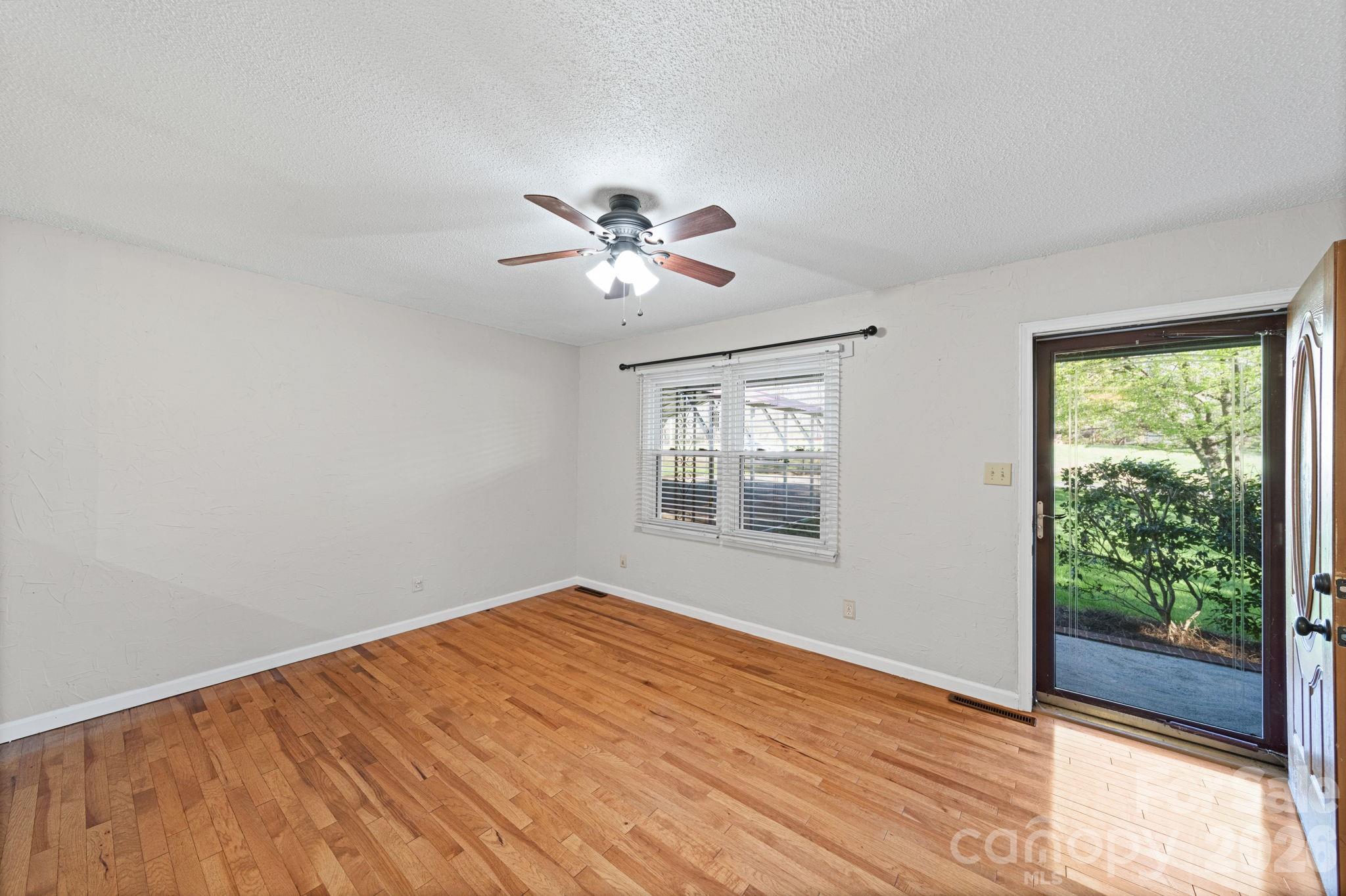 3227 Westover Road Statesville, NC 28677 - Photo 22 of 37 a view of an empty room with a window and wooden floor