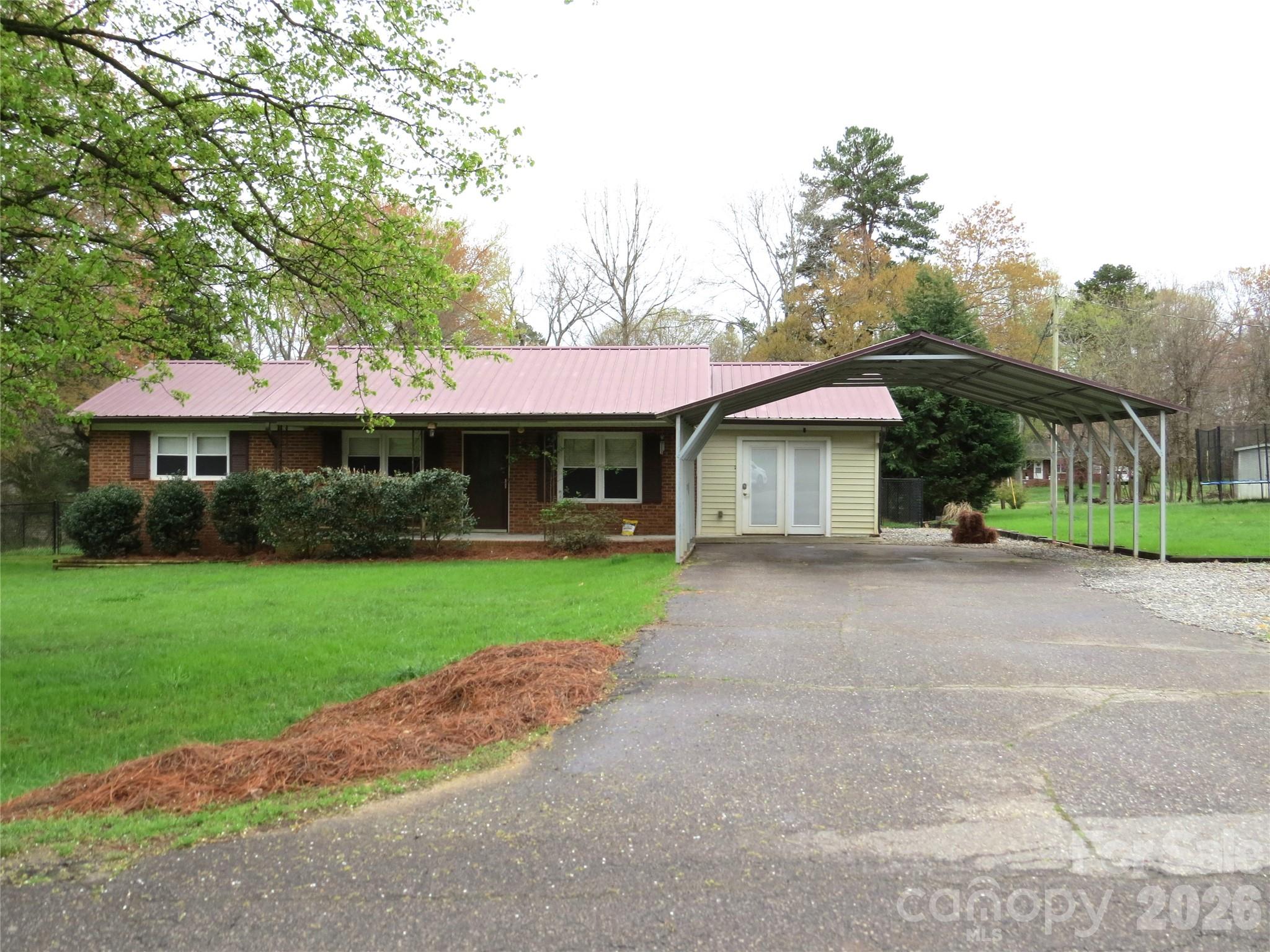 3227 Westover Road Statesville, NC 28677 - Photo 24 of 37 a front view of a house with a yard and garage