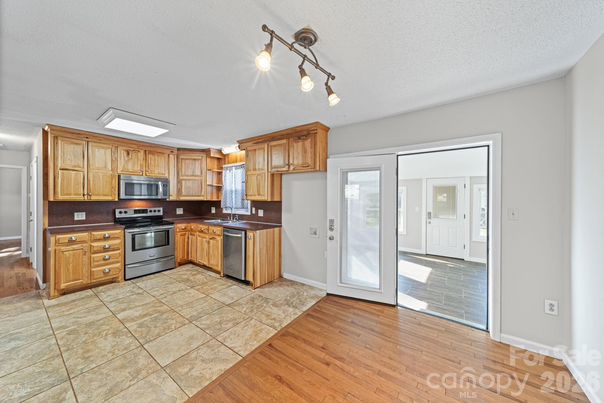 3227 Westover Road Statesville, NC 28677 - Photo 3 of 37 a kitchen with granite countertop a window and stainless steel appliances