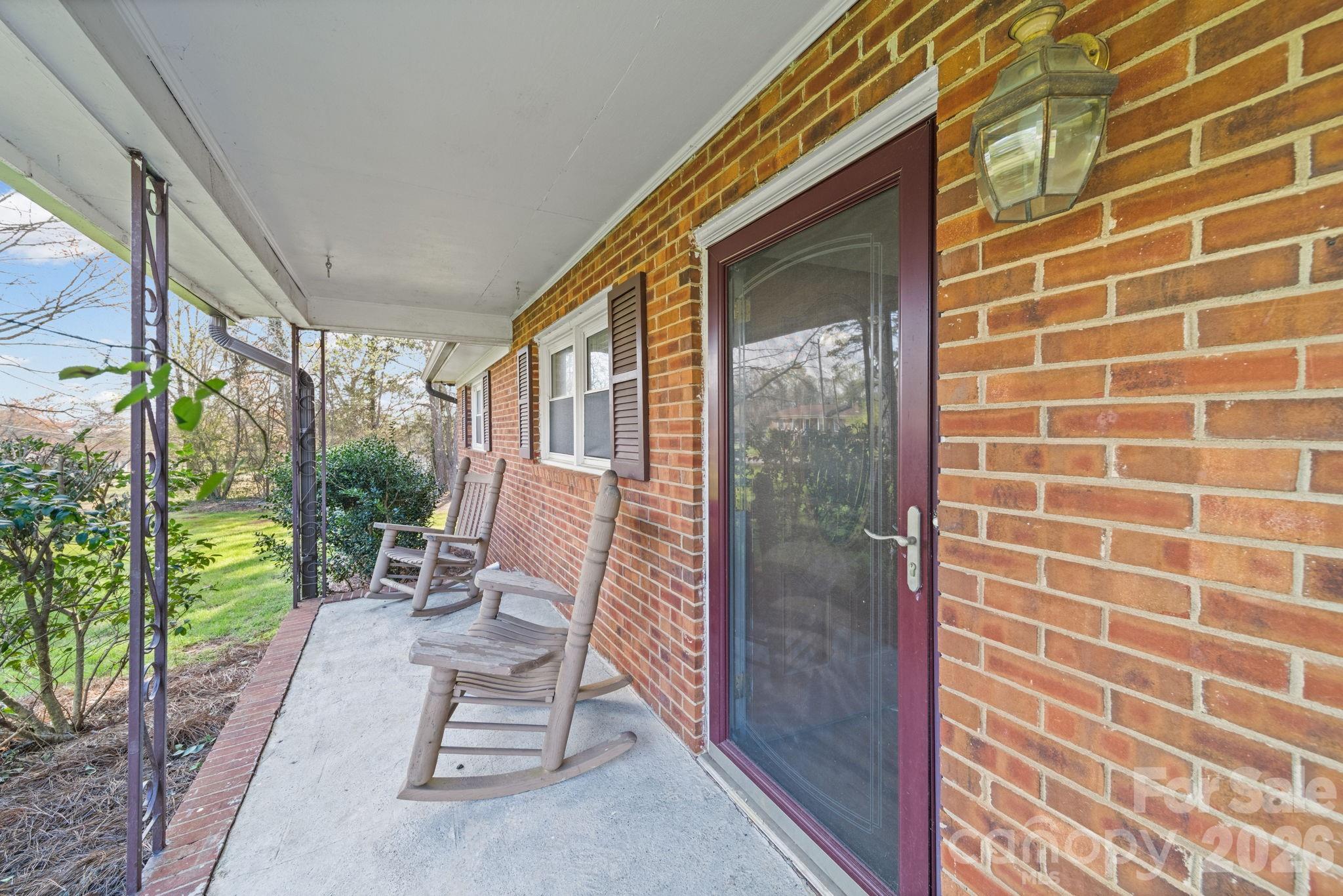 3227 Westover Road Statesville, NC 28677 - Photo 33 of 37 a view of a balcony with chairs and floor to ceiling window