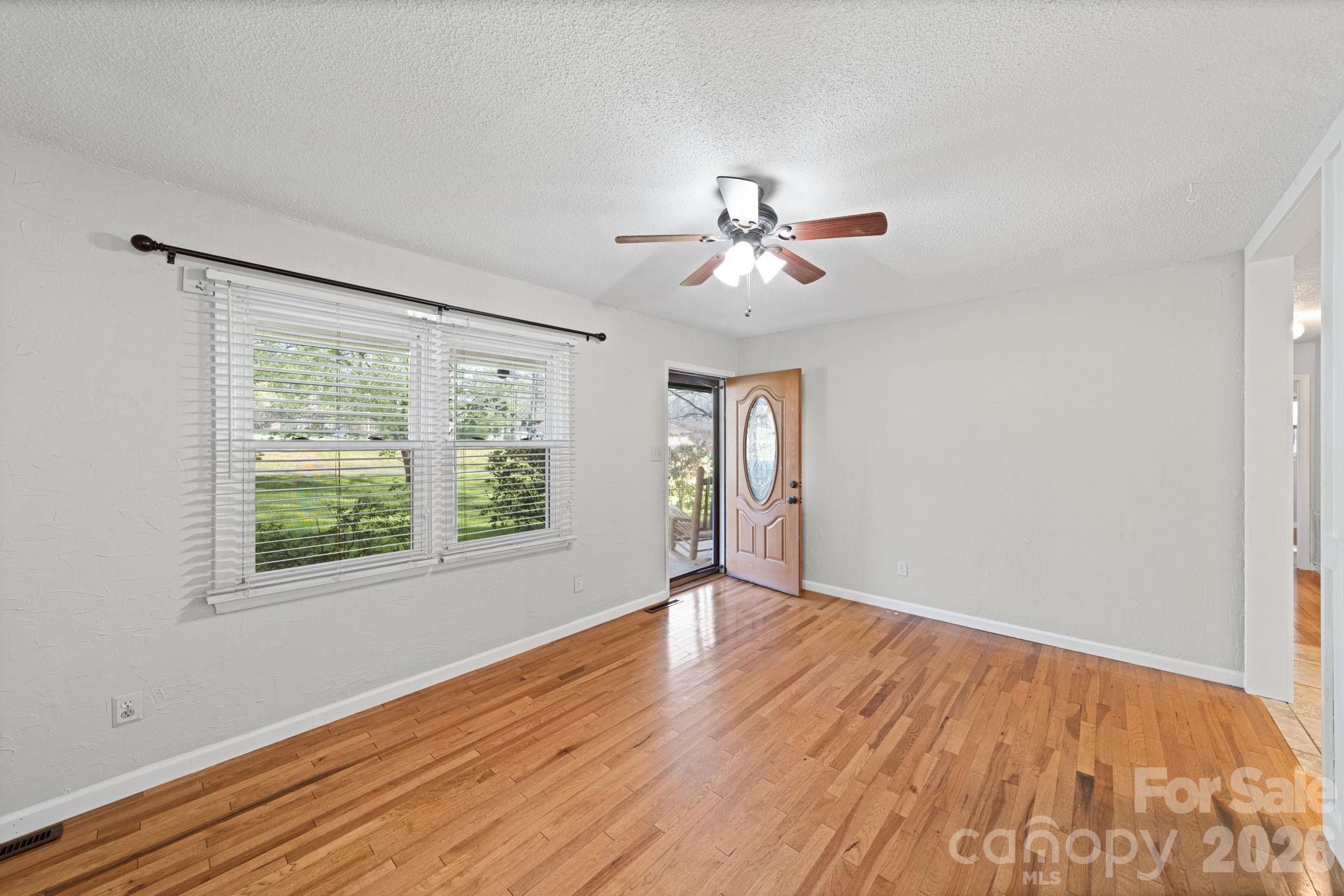 3227 Westover Road Statesville, NC 28677 - Photo 5 of 37 a view of an empty room with a window and wooden floor