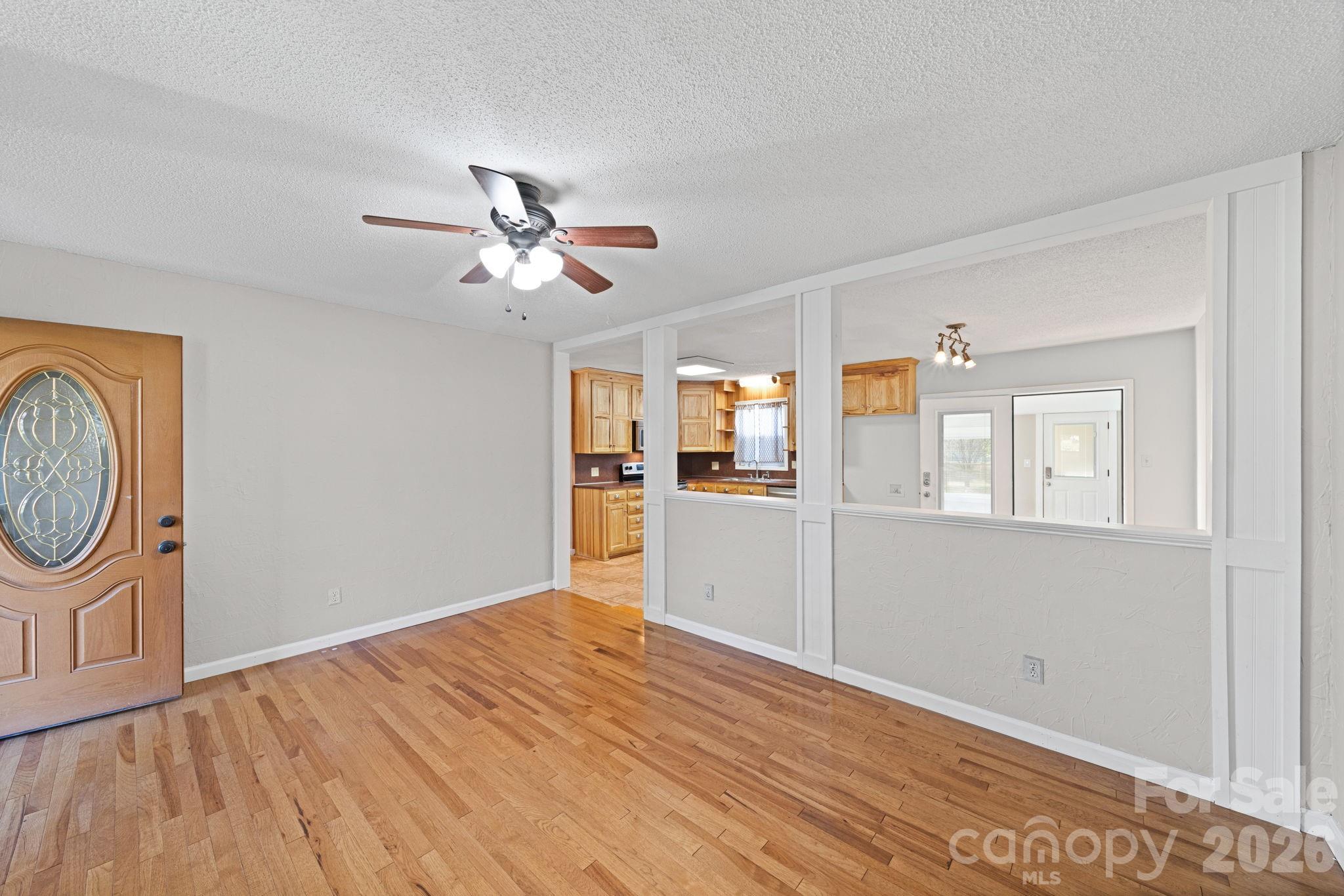 3227 Westover Road Statesville, NC 28677 - Photo 6 of 37 a view of empty room with wooden floor and fan