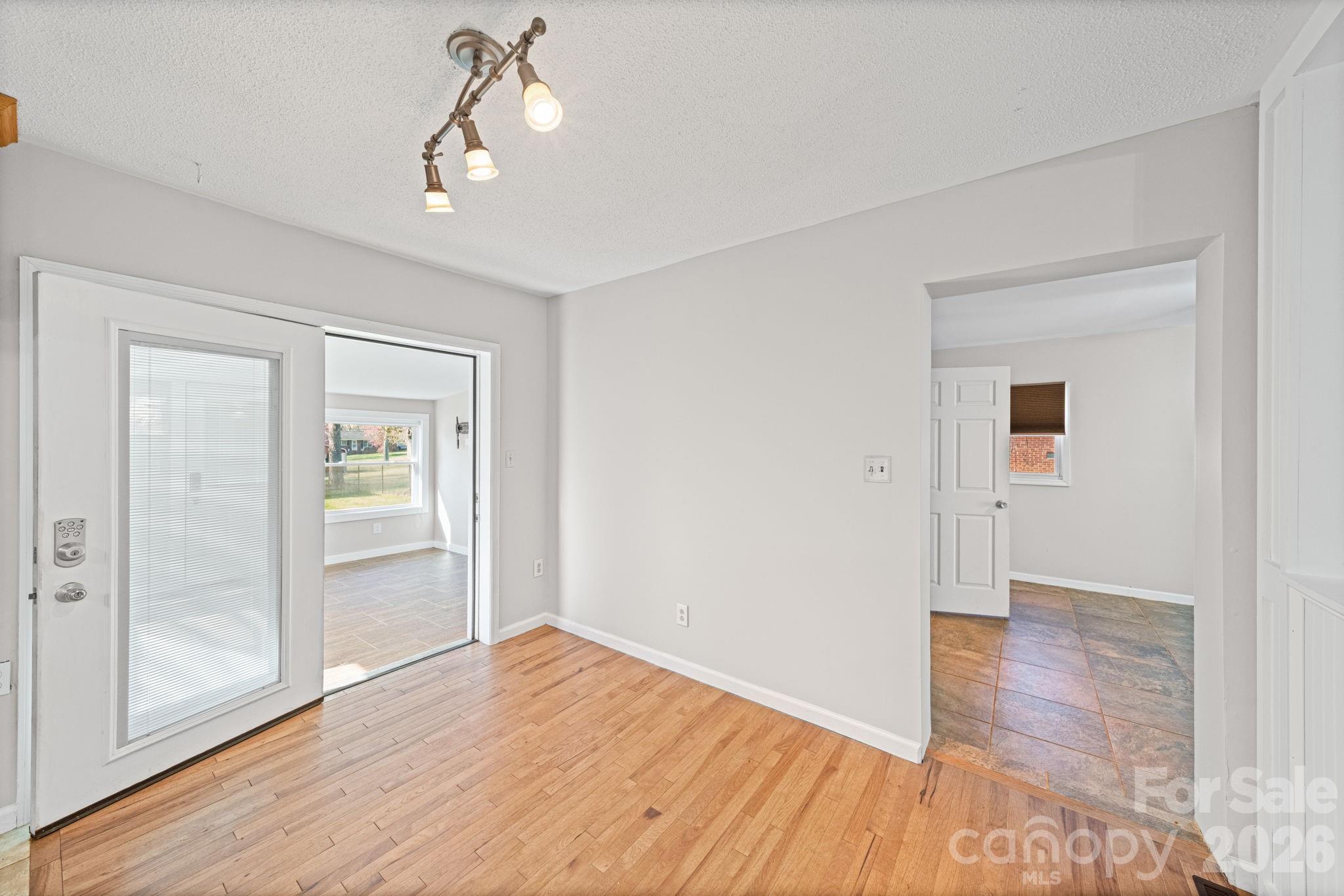 3227 Westover Road Statesville, NC 28677 - Photo 9 of 37 wooden floor in an empty room with a window