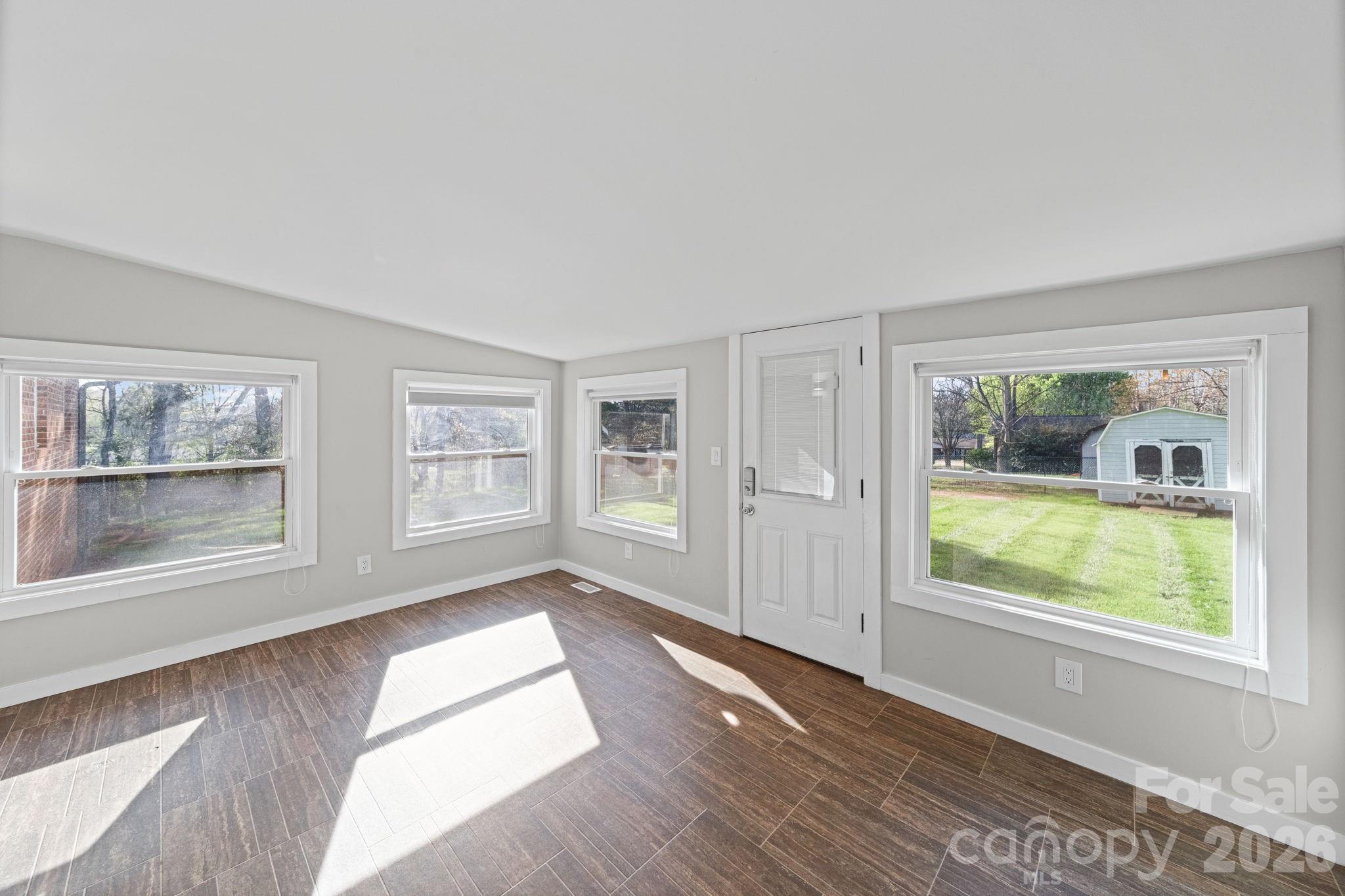 3227 Westover Road Statesville, NC 28677 - Photo 10 of 37 a view of an empty room with wooden floor and a window