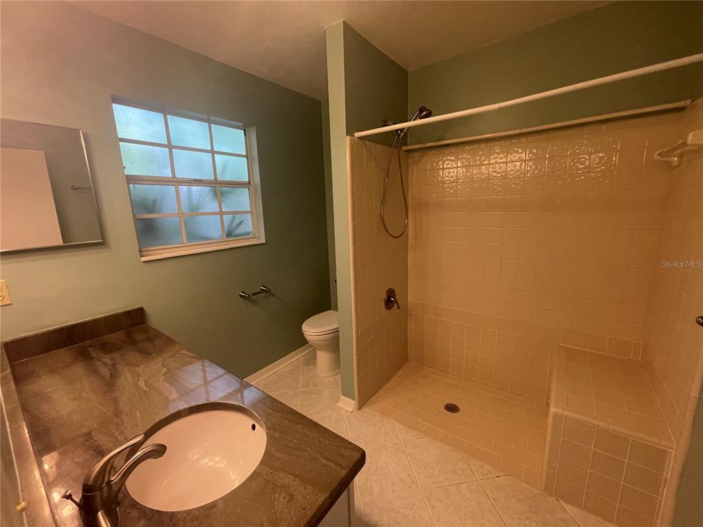 324 Northwest 48th Boulevard, Unit K Gainesville, FL 32607 - Photo 13 of 16 a bathroom with a sink toilet and shower
