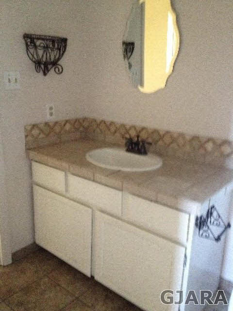 2721 Patterson Road, Unit 802 Grand Junction, CO 81506 - Photo 9 of 12 a bathroom with a granite countertop sink and a mirror