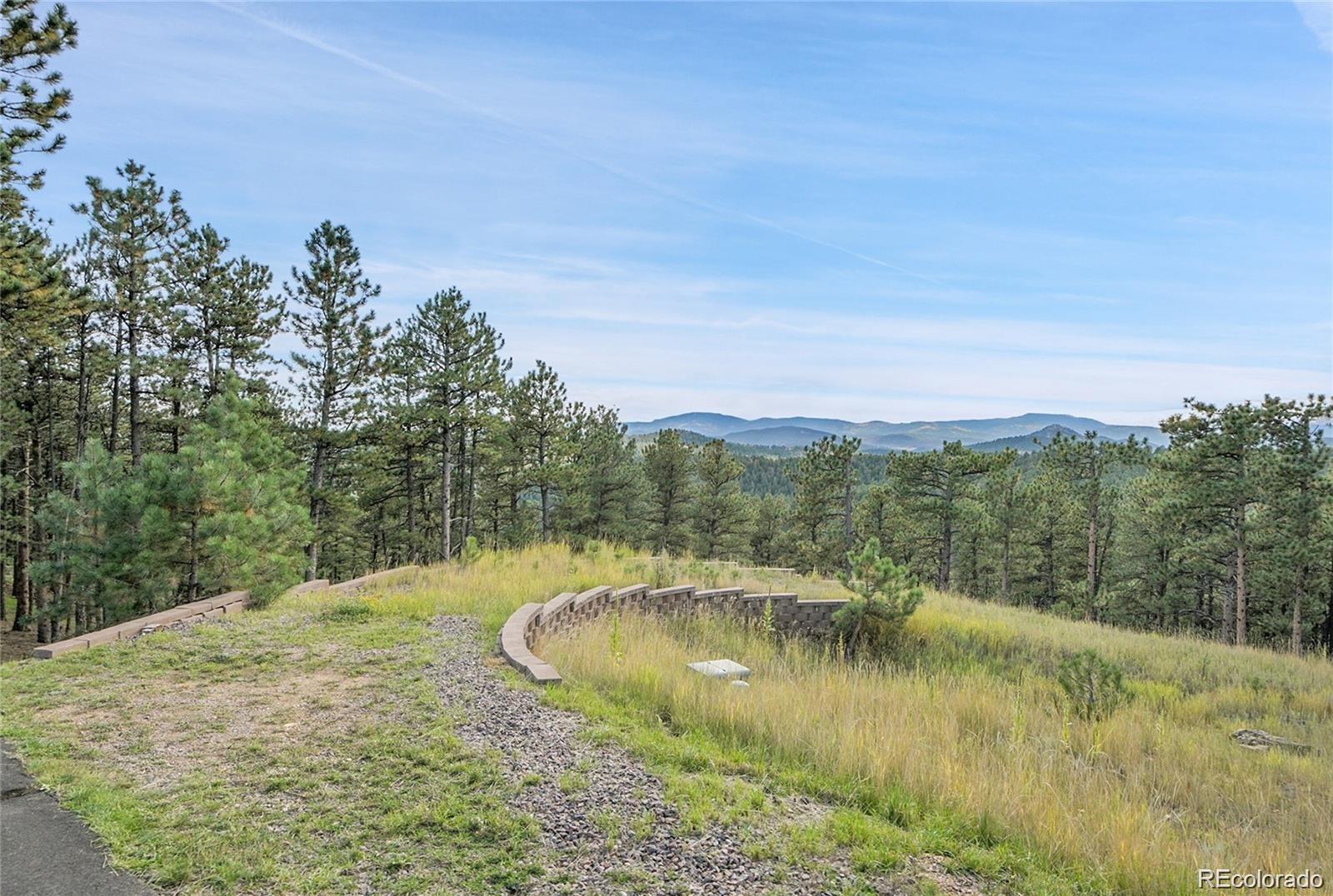2317 Wieler Road Evergreen, CO 80439 - Photo 1 of 26 a view of a town with mountains in the background