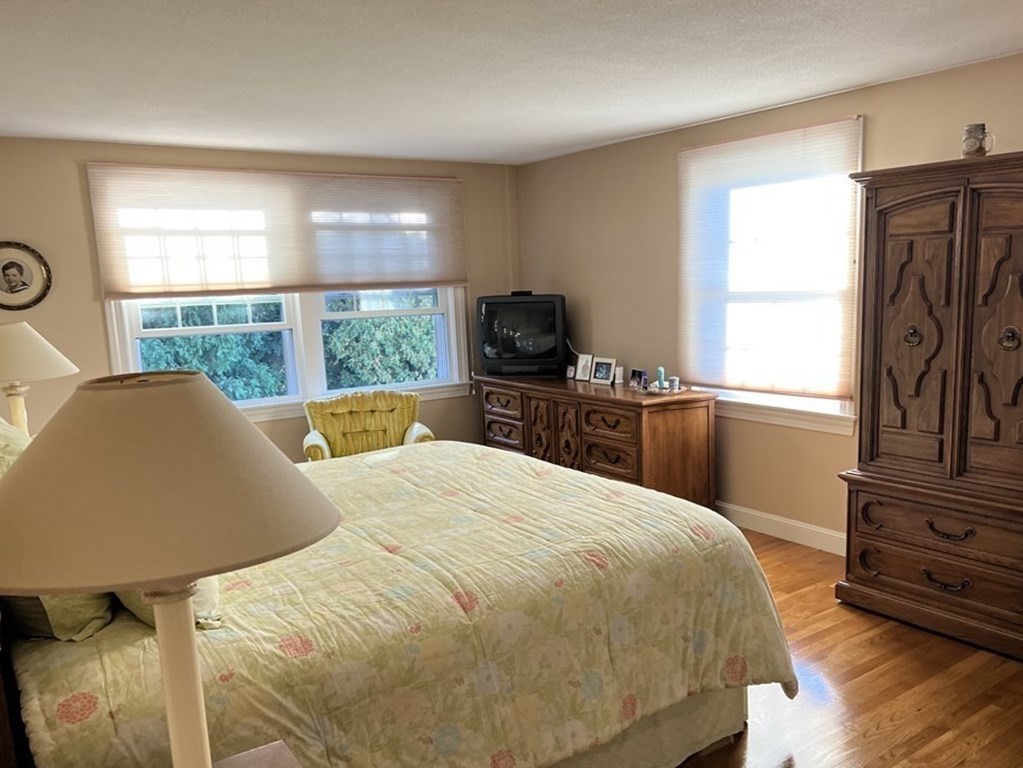 15 Leo Road Marblehead, MA 01945 - Photo 17 of 21 a bedroom with a bed and wooden floor