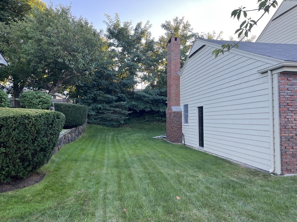 15 Leo Road Marblehead, MA 01945 - Photo 3 of 21 a view of a backyard with potted plants and large tree