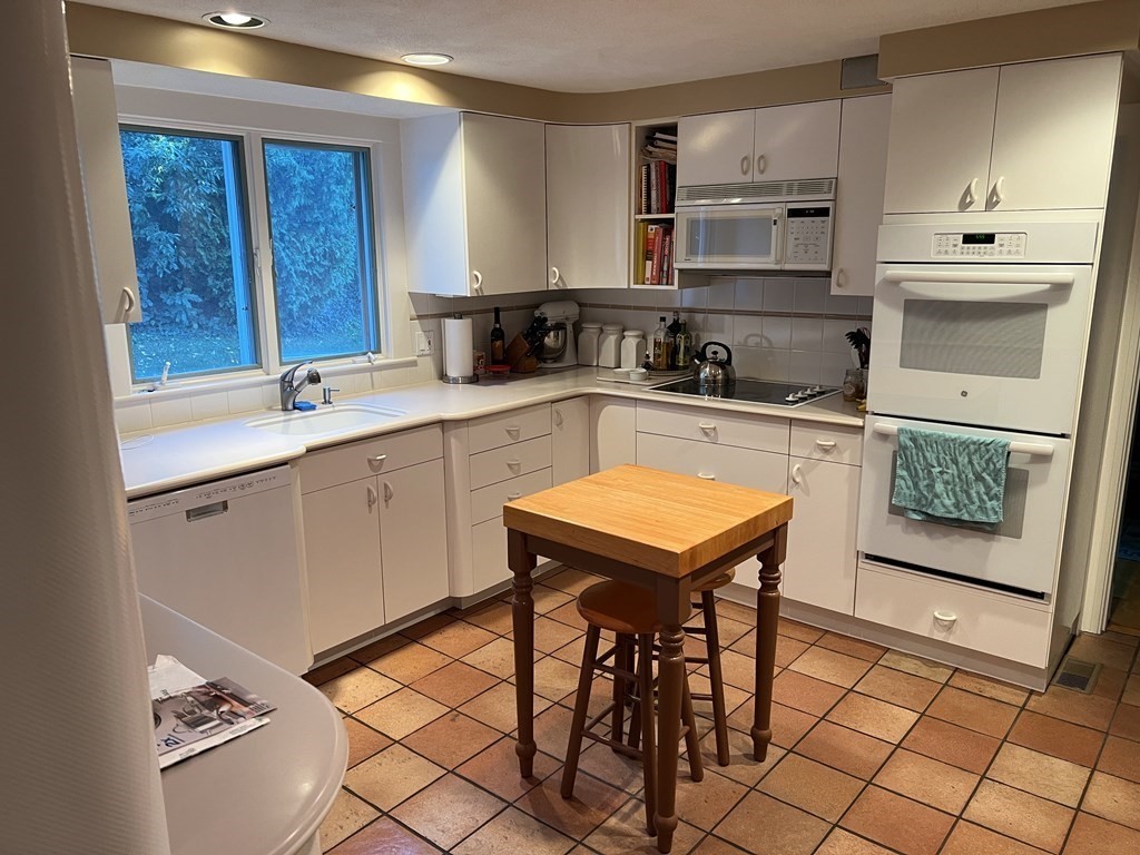 15 Leo Road Marblehead, MA 01945 - Photo 5 of 21 a kitchen with stainless steel appliances granite countertop a stove a sink and a microwave