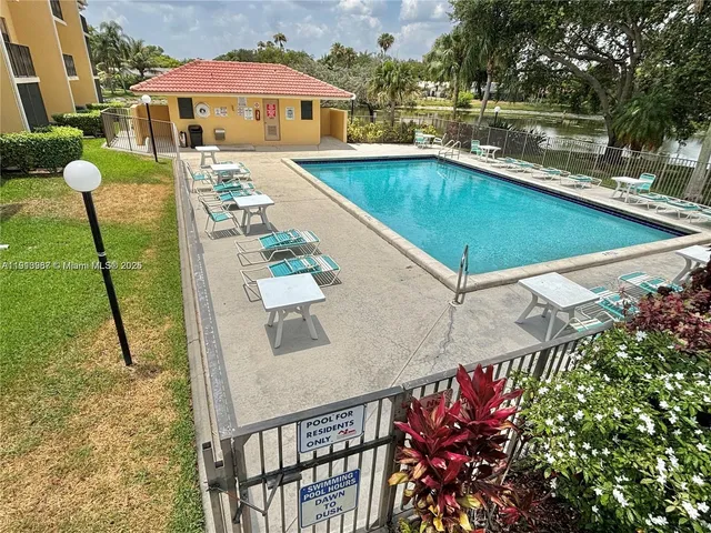 a view of swimming pool with outdoor seating and plants