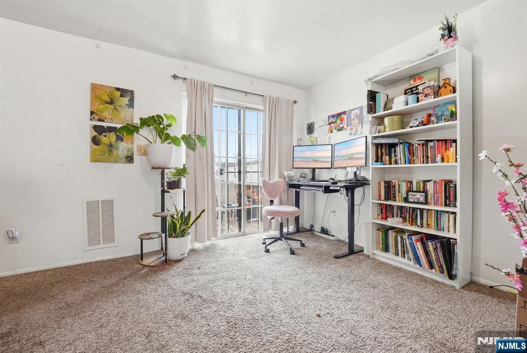 120 Carnegie Place Union, NJ 07088 - Photo 17 of 28 a view of a workspace with bookshelf and a window