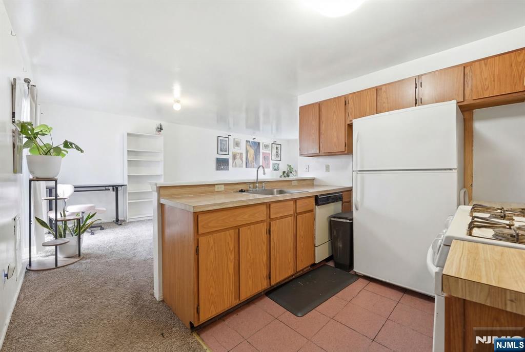 120 Carnegie Place Union, NJ 07088 - Photo 2 of 28 a kitchen with sink cabinets and white appliances