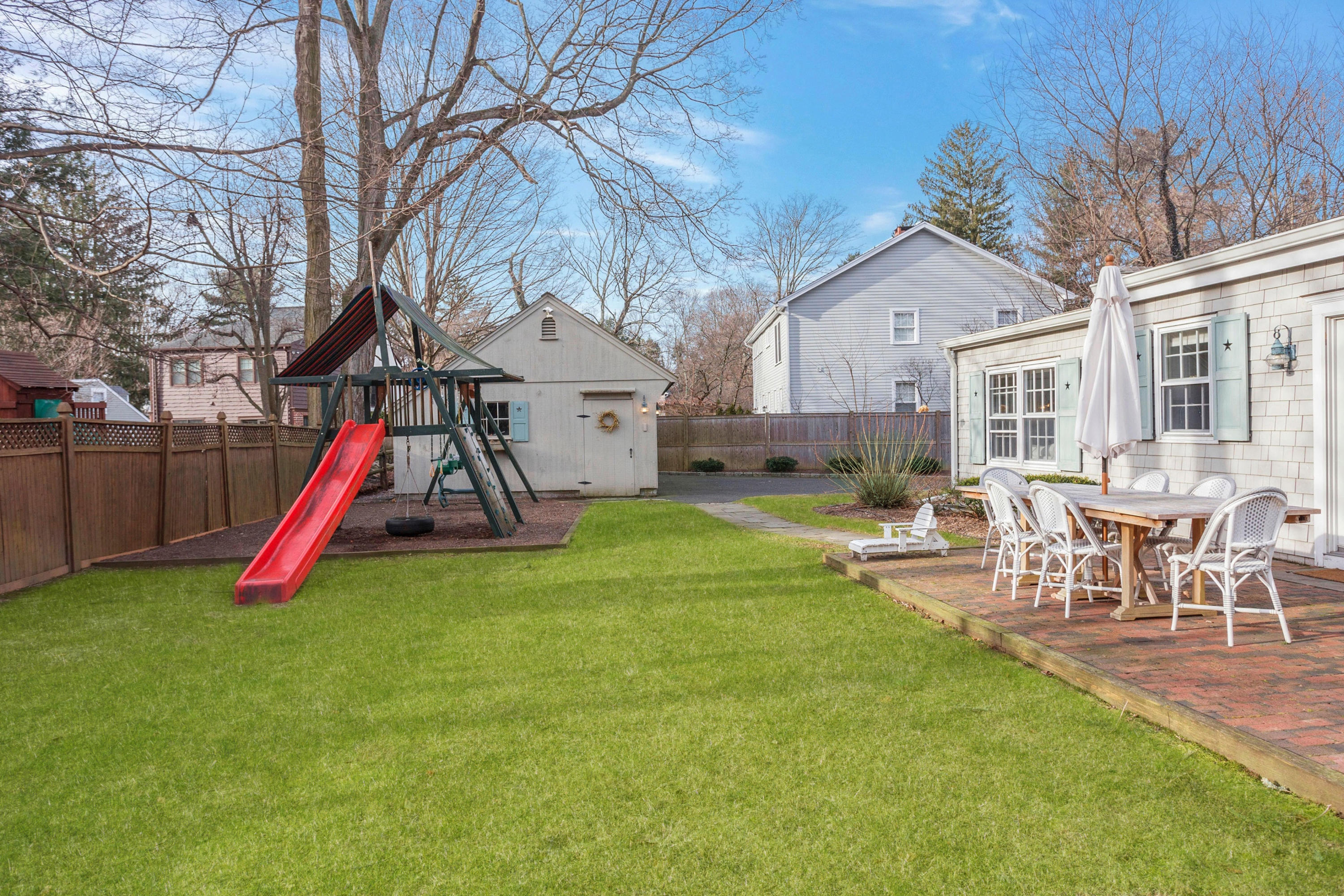 204 Middlesex Road Darien, CT 06820 - Photo 20 of 23 a view of a house with a backyard and a slide