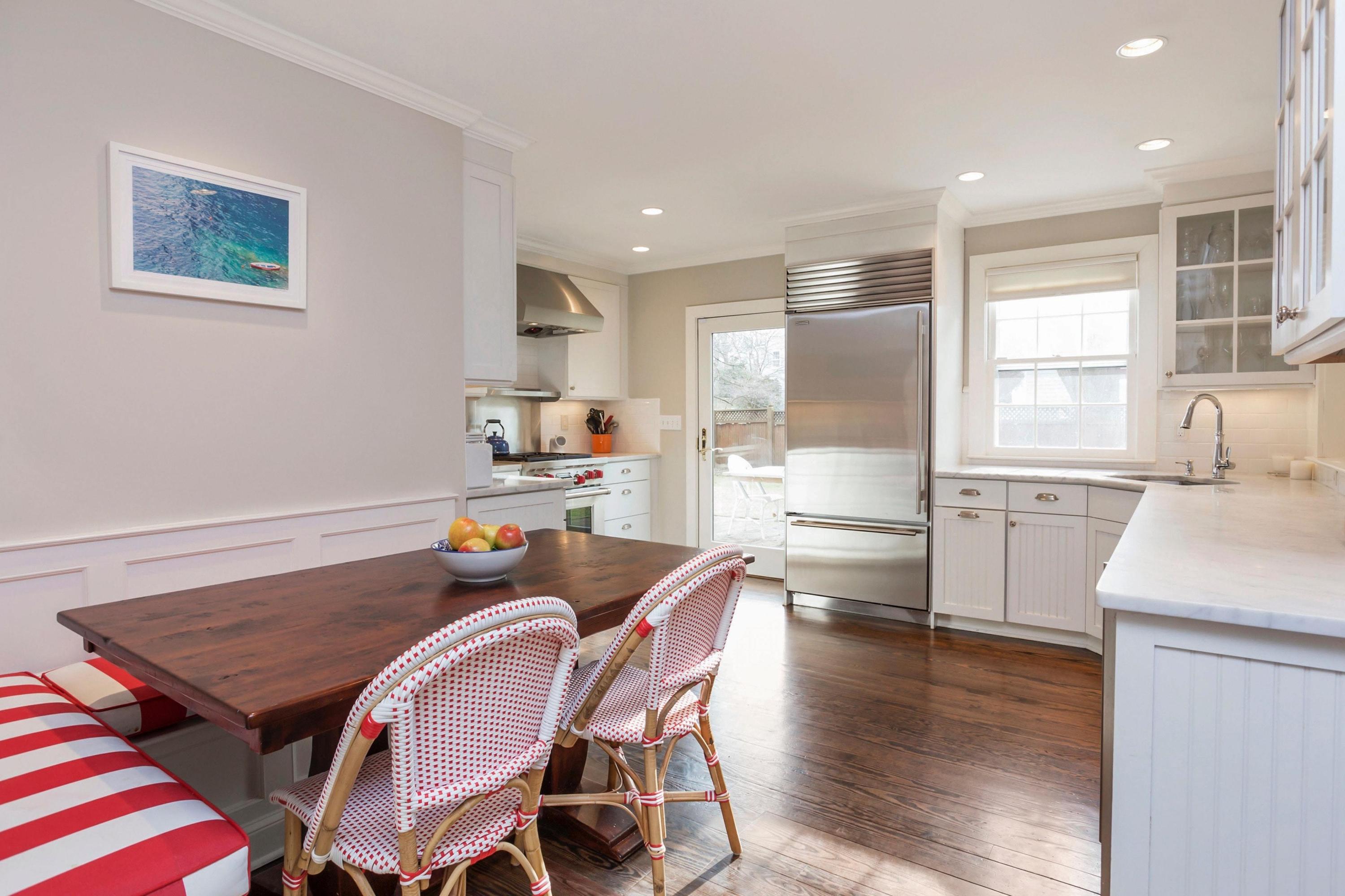 204 Middlesex Road Darien, CT 06820 - Photo 10 of 23 a kitchen with stainless steel appliances granite countertop a stove top oven a sink a dining table and chairs with wooden floor