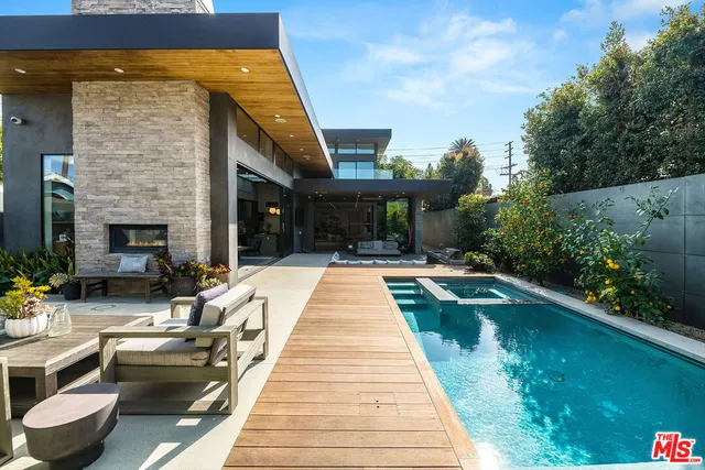 a view of swimming pool with outdoor seating and plants