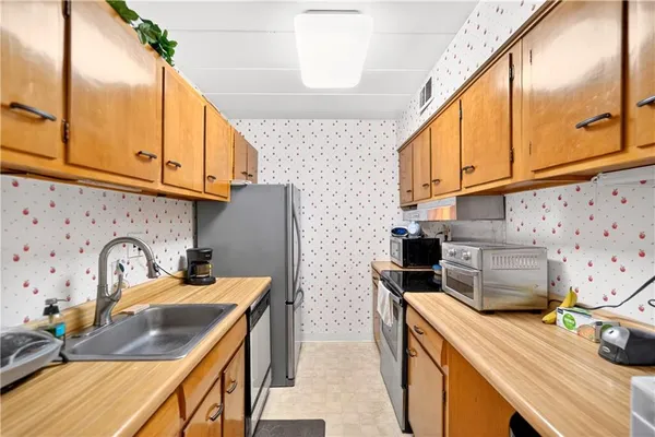 a kitchen with stainless steel appliances a sink a stove and a refrigerator