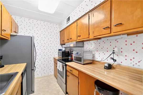 a kitchen with stainless steel appliances a sink a stove and a refrigerator