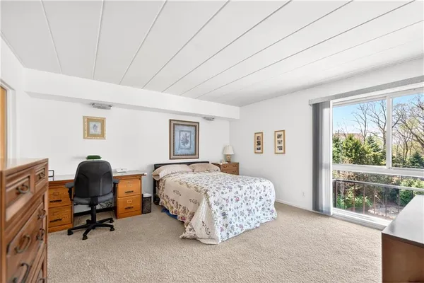 a bedroom with furniture and a window