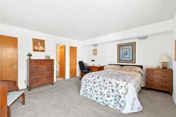a bedroom with a bed and dresser